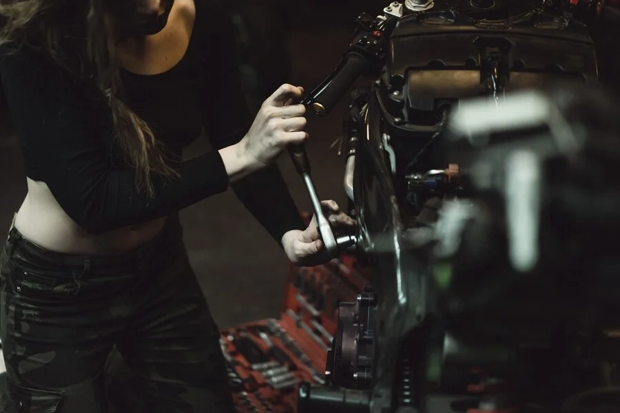 beautiful girl with long hair garage repairing motorcycle 1321 1396