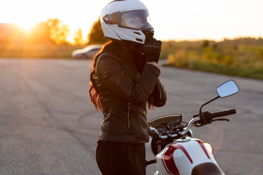 side view woman taking off her helmet motorcycle 23 2148685262