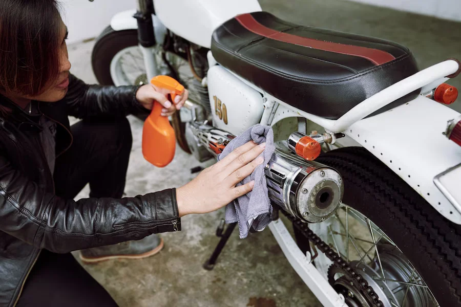 top angle view cropped biker polishing pipe his motorcycle 1098 19056