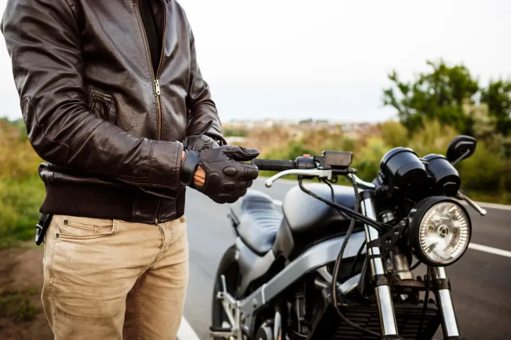 young handsome man posing near his motorbike wearing gloves 176420 2445